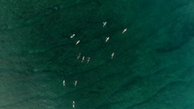 Surfers waiting for waves. Wild islands of Indonesia. Sumatra. tropical paradise. Telos, Banyak, Mentawai. drone shooting. Wild beaches, blue lagoons, coral reefs. Aerial view. High quality 4k footage