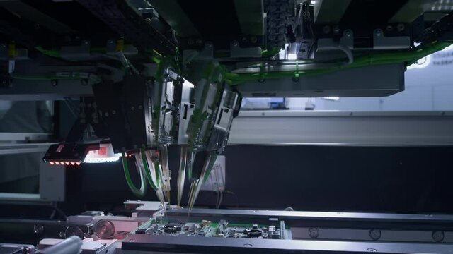Printed circuit boards production factory, assembly inside the machine. Technological process. Needle automatic equipment diagnose and test chips and processors. Installation of SMD components
