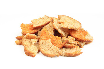 Toasted bread pieces isolated on white background. Pile of flavored crispy snack
