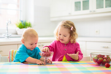 Child eating breakfast. Kid with milk and cereal.