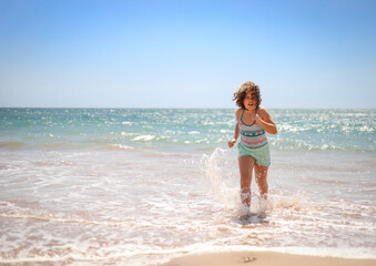 Girl running on the beach.