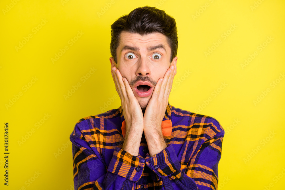 Poster photo of young man unhappy upset shocked surprised fake novelty news isolated over yellow color back