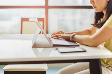 Woman working at home office hand typing on keyboard computer.