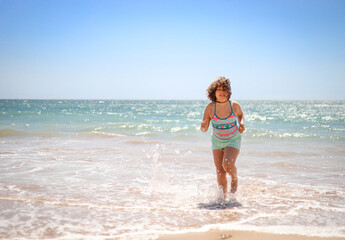 Girl running on the beach.
