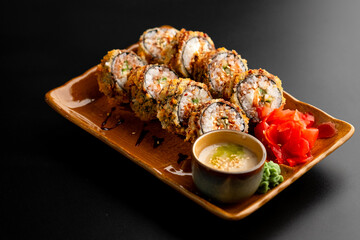 Sushi and rolls, Japanese sea cuisine. Served plates for the restaurant menu on a black background.