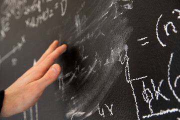 Mathematical formulas on dark black chalk board