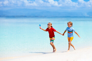 Kids playing on beach. Children play at sea.