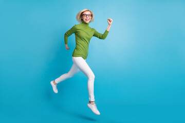 Fototapeta na wymiar Full size photo of young happy positive smiling girl running fast speed in air isolated on blue color background