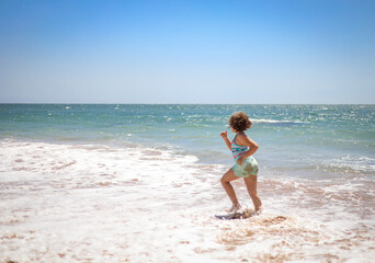 Fototapeta na wymiar Girl running on the beach.