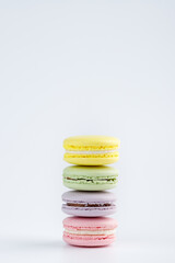 Stack of colorful macaroons on a white background