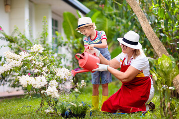 Woman and child gardening. Grandmother and kid.