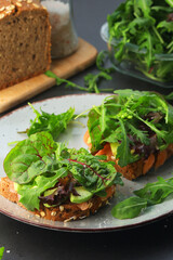 Sandwiches with salmon, avocado and salad