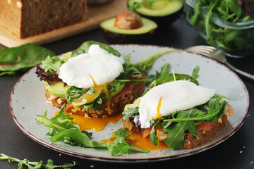Homemade sandwiches with salmon, avocado and poached eggs