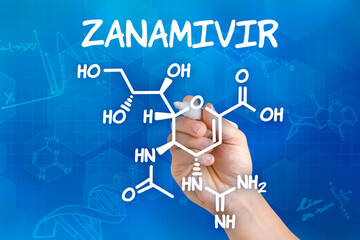 Hand with pen drawing the chemical formula of Zanamivir