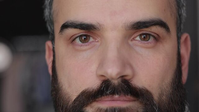 Close up of male face. Attractive man opening his beautiful brown eyes with long eyelashes. Highly detailed portrait of human face.