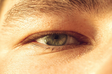 European guy's eye close up. part of the face macro. the eyeball is extremely close. Human pupil