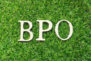 Alphabet letter in word BPO (Abbreviation of Business Process Outsourcing) on green grass background