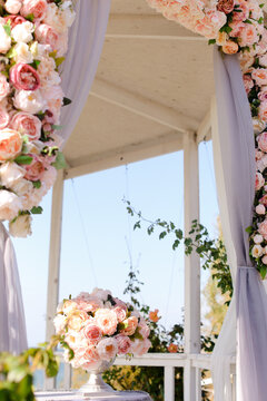 Wonderful wedding arch decorated by pink and white flowers.
