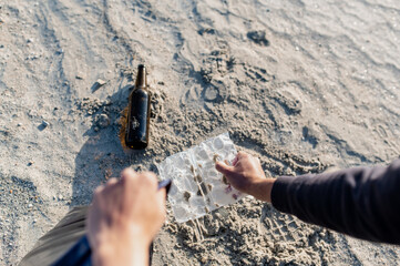 unrecognizable volunteer saving sea from plastic pollution. Man cleaning on the beach