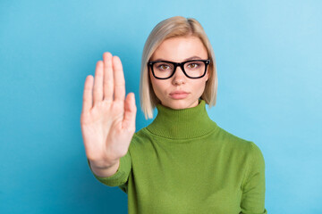 Portrait of attractive strict serious girl showing stop sign palm decision isolated over bright...