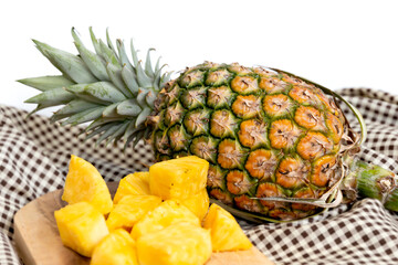 Fresh sliced pineapple on wooden tray on table.