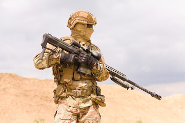 Close-up photo of special force soldier with sniper rifle