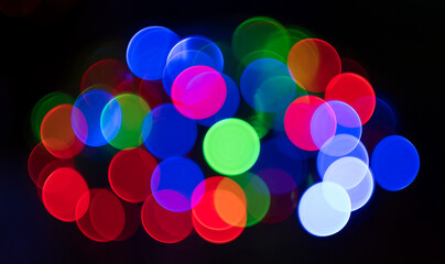 Multicolored circular bokeh on black background . red , blue and green lights . 