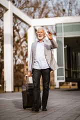 Senior businessman is arriving from business trip.