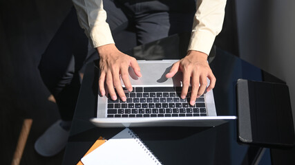 Fototapeta na wymiar Above shot man typing on laptop computer.