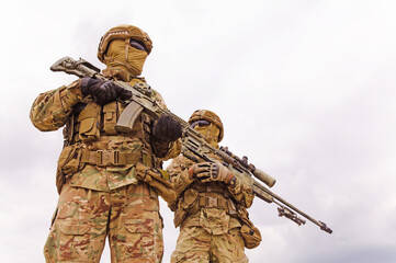 Equipped and armed special forces soldiers with rifles close up