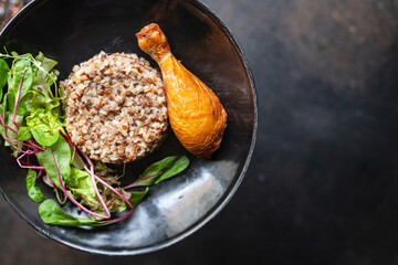 buckwheat porridge with chicken leg leaves green petals lettuce mix fresh healthy appetizer trend diet meal snack copy space food background rustic. top view keto or paleo diet