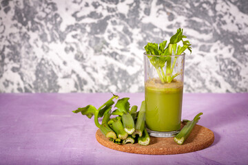 Healthy Celery diet for the treatment of incurable mysterious diseases. Fresh celery juice squeezed out on a juicer.drink, vegetable juice, studio shot