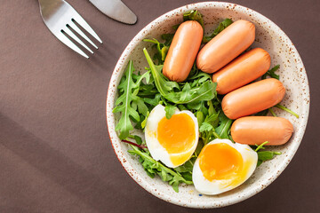 sausages salad poached egg leaves green petals lettuce mix fresh healthy appetizer trend diet meal snack copy space food background rustic. top view keto or paleo diet