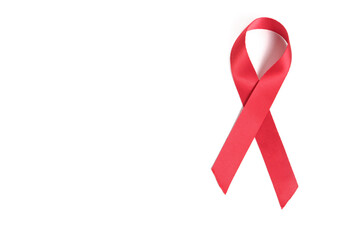 Red ribbon on white background is symbol of disease AIDS and drug abuse.