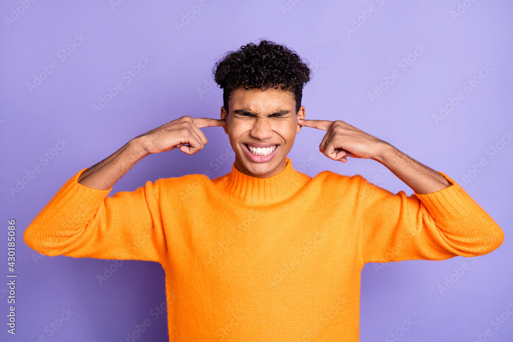 Poster Photo of unhappy irritated dark skin man hold fingers ears cover loud noise isolated on purple color background