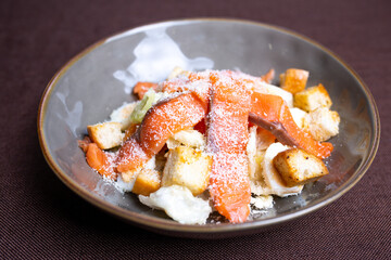 fish salad with salmon and breadcrumbs in a plate
