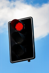 Traffic light with red light to stop and do not cross road.