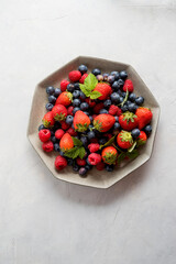 Isolated plate of blueberries, strawberries, raspberries.
