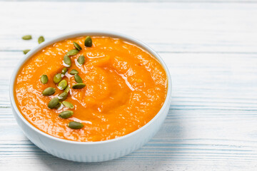 Creamy roasted pumpkin  soup  in a bowl. Space for text.