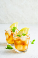Apple cider summer drink, apple iced tea in glasses. Space for text.