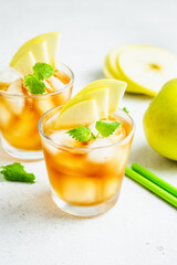 Apple summer refreshing ice mocktail, apple iced tea in glasses. Space for text.