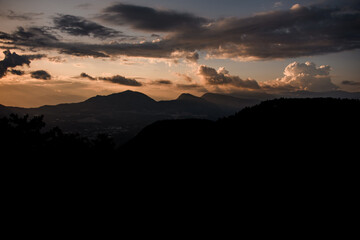 majestic mountain landscape with colorful vivid sunset on the cloudy sky, nature outdoor travel background.