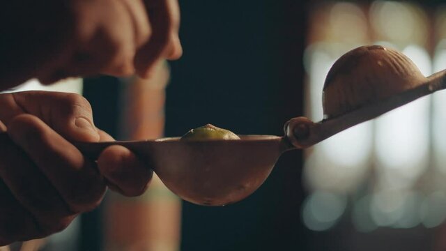Close up, fruit squeezer and placing half of lime in utensil making citrus juice