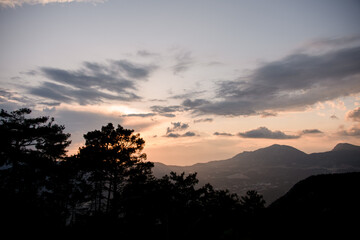awesome mountain landscape with colorful vivid sunset on the cloudy sky, nature outdoor travel background.