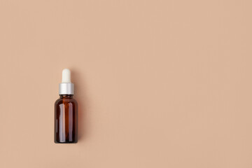 amber dropper glass bottle on beige background. Mockup