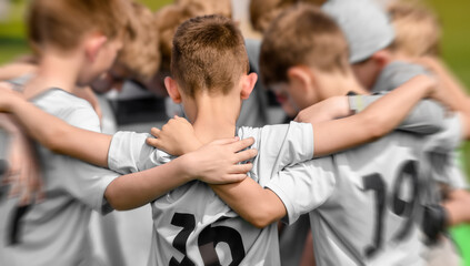 Fototapeta na wymiar Junior Sports Team Celebrating Winning. Happy Kids Huddling And Standing in Team in a Circle. Boys in White Soccer Jersey Shirts