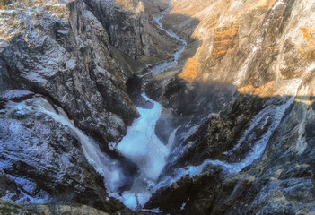 Fototapeta na wymiar Voringfossen waterfall in early spring, leftover ice left over from winter in the Mabodalen valley in the Eidfjord municipality in Norway