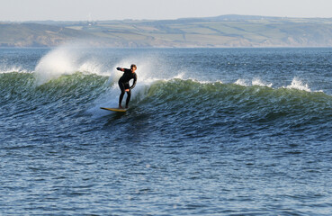 Stylish surfer on a wave in Devon