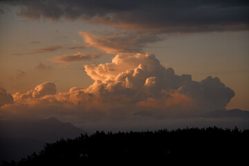 Majestic view of sky with big colorful clouds over mountain silhouette. Beauty in nature.