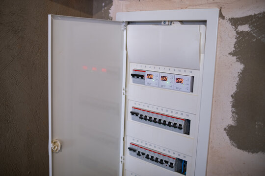 White electrical panel with different wires. The danger
